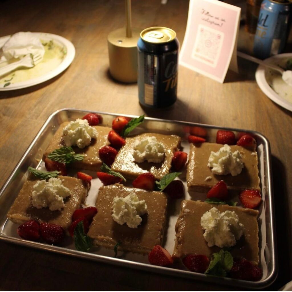 Food served in a family style adds to the community-building experience, like the rhubarb bars at the Next Door Dinners' June 18th event.