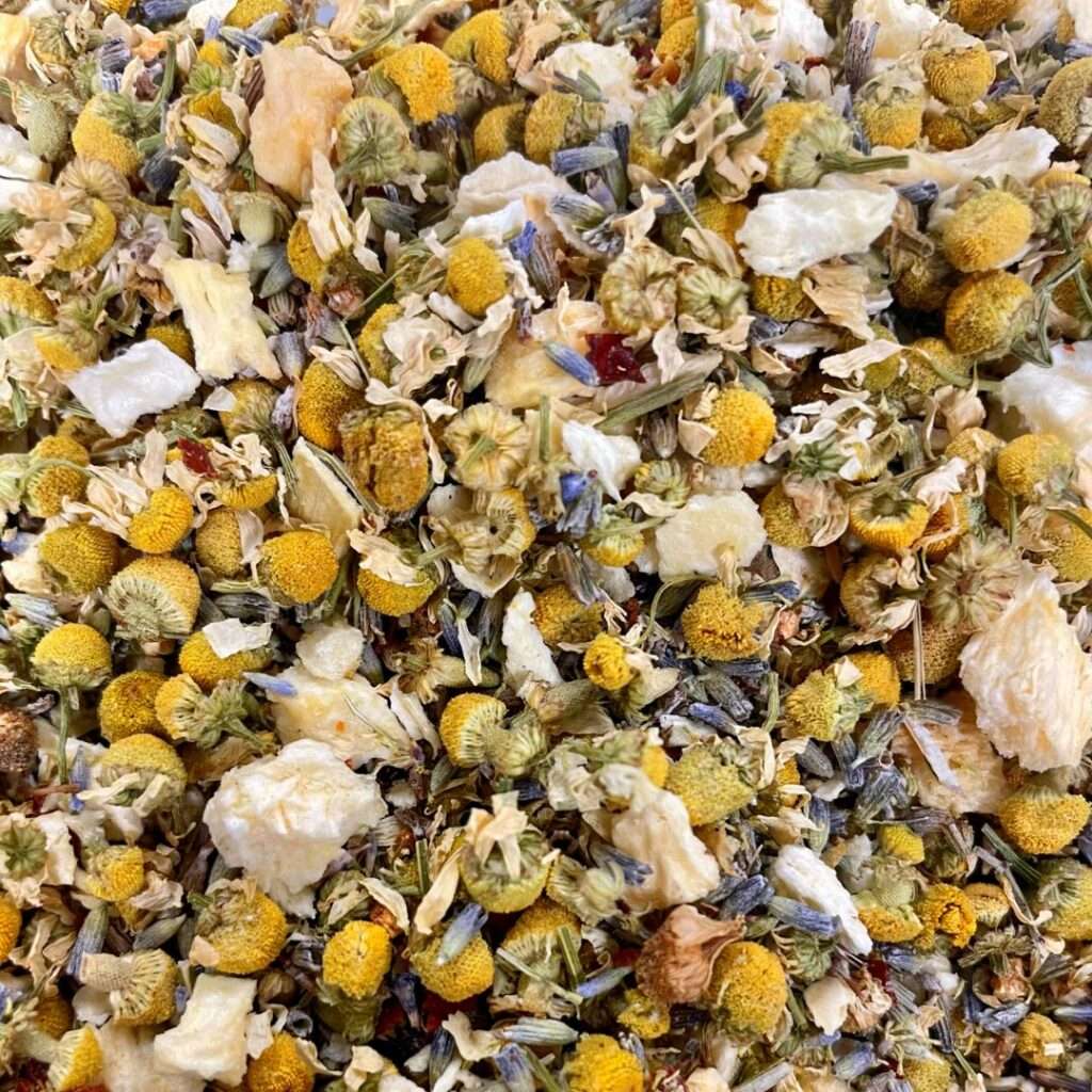 A loose-leaf herbal tea with chamomile flowers, lavender, and freeze-dried pineapple, offering a soothing, floral, and calming blend.