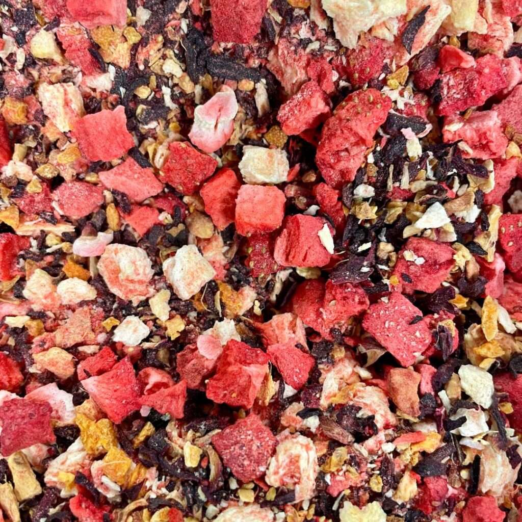 A vibrant loose-leaf tea blend with freeze-dried strawberry, pineapple, hibiscus, and botanicals, creating a juicy, refreshing mix.